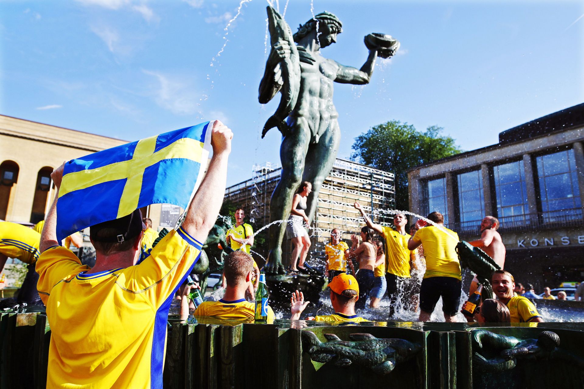 Supporters of Sweden celebrate in the fountain at Gotaplatsen square in central Gothenburg, Sweden